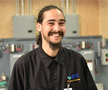 SJVC electrician program student standing in electrician classroom