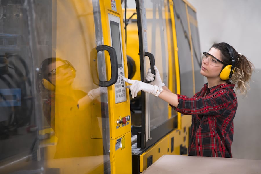woman operating yellow machinery