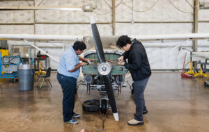 technicians work on plane